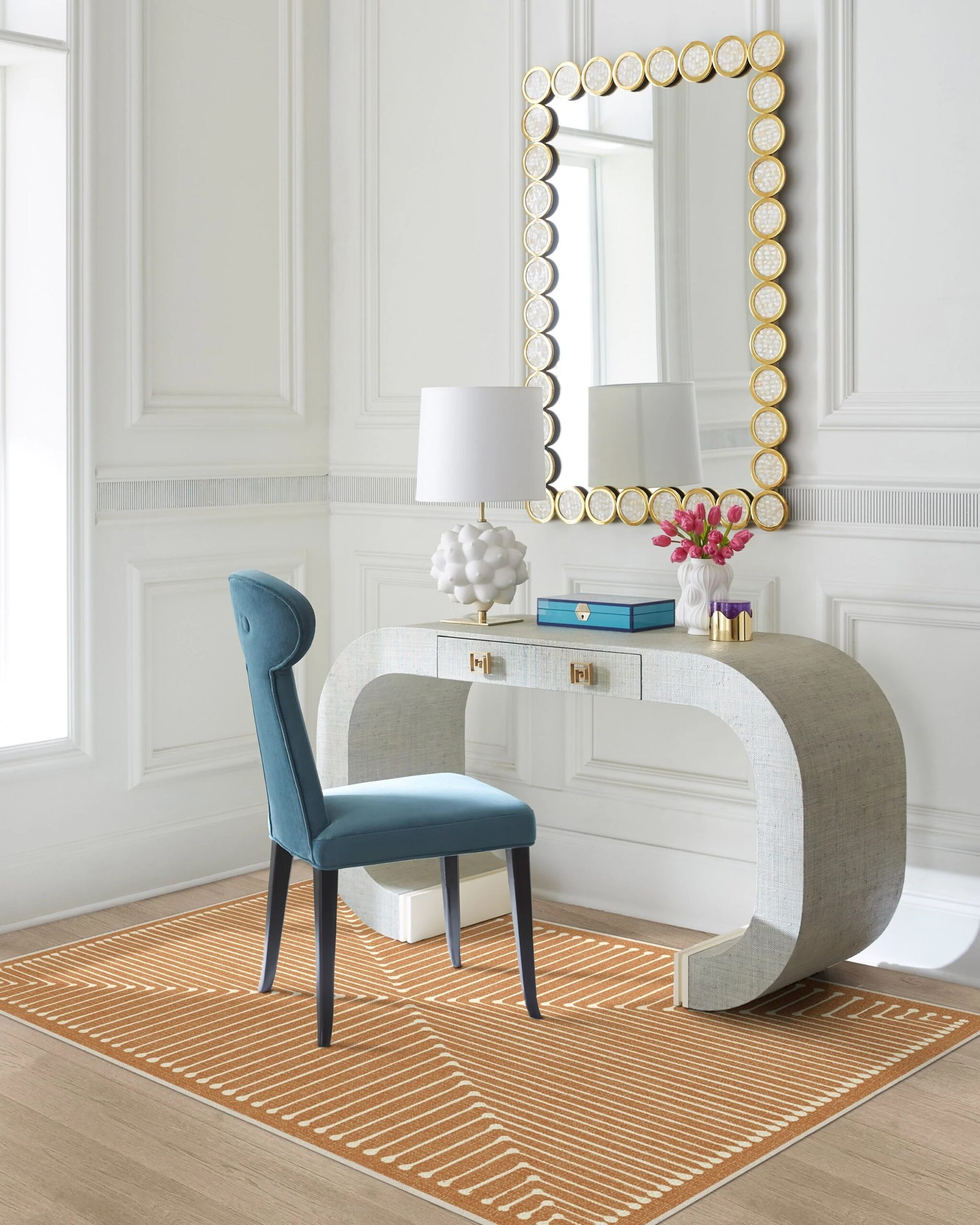 Copper rug under a console and blue velvet chair from our affirdable yc guide.