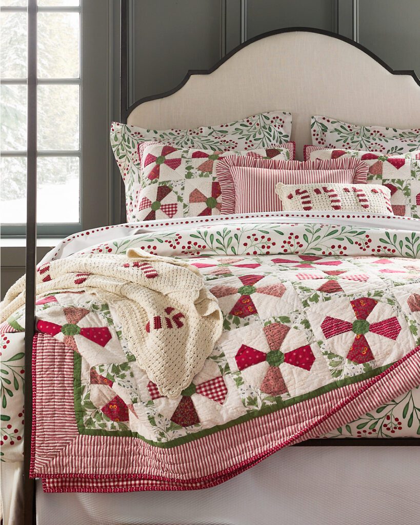 Garnet Hill Candy Cane red and white throw blanket on a holiday-themed bed from our modern holiday hosting ideas guide.