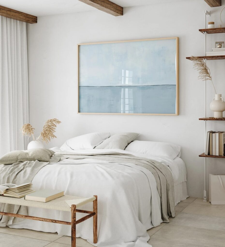 Bedroom with white linens and soft blue statement art from our interior design resolutions for 2026 guide.