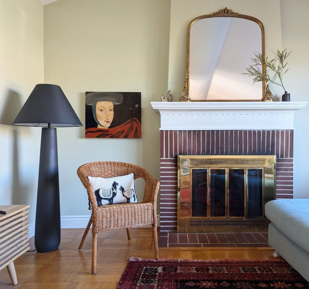 Polar cement floor lamp aside a rattan chair and fireplace from our renter friendly design guide.