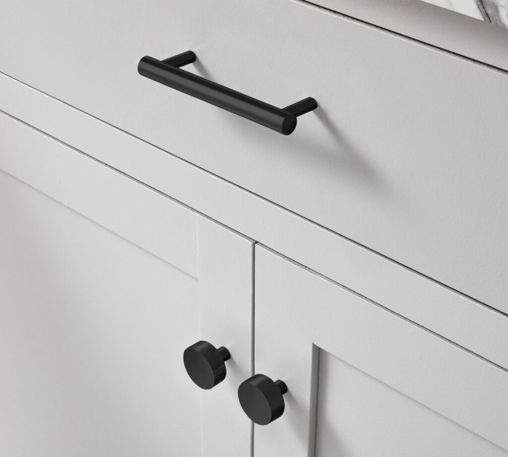 Black bathroom knobs on white cabinets from Pottery Barn.