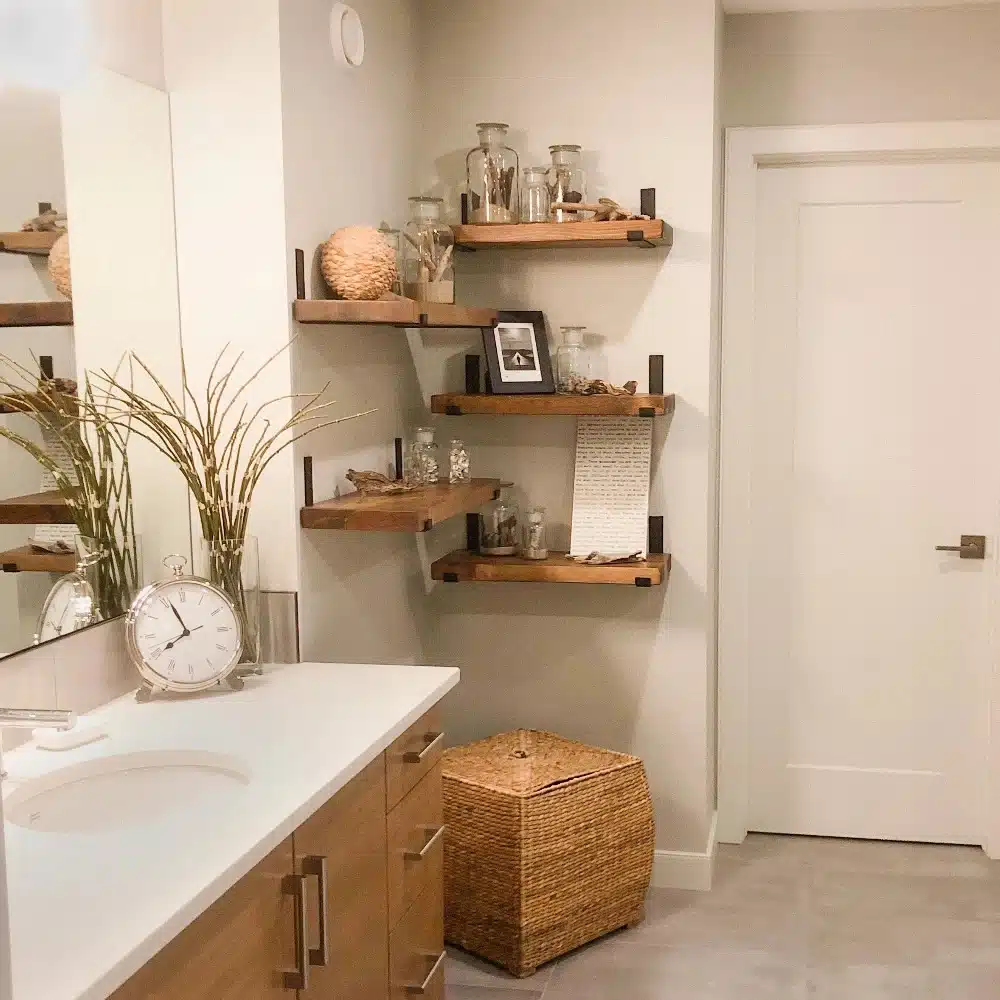 Wood shelving adding storage to an empty corner in a modern bathroom.