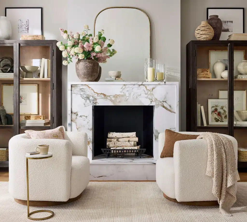 Modern living room wall decor includes a mirror above a marble fireplace mantel.